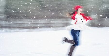 girl running while snowing